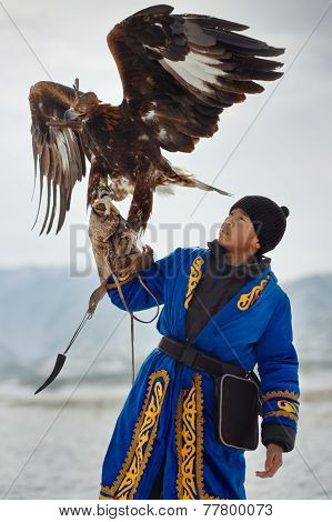 NURA KAZAKHSTAN - FEBRUARY 23: Eagle on kid's hand in Nura near Almaty on February 23 2013 in Nura