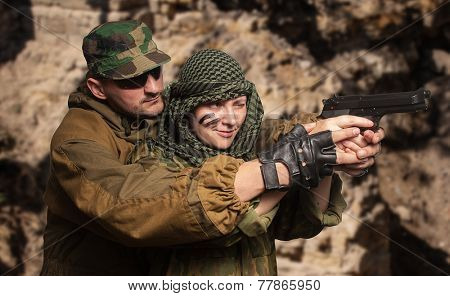 Portrait of the woman to trained bullet shooting with instructor