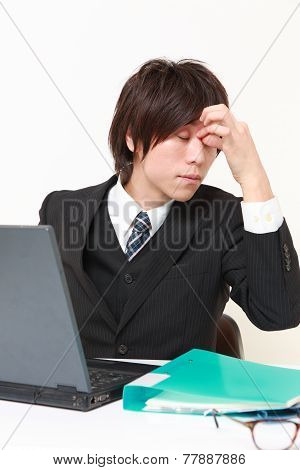 businessman suffers from Asthenopia