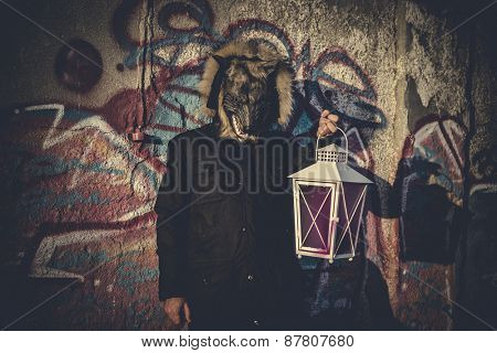 man with mask wolf and lamp with colored smoke