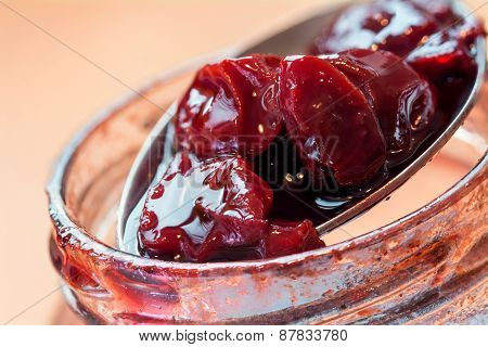 Spoon Takes Cherry Jam Out Of The Jar