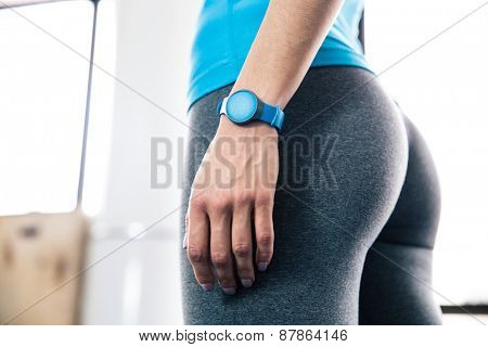 Side view portrait of female body with fitness tracker