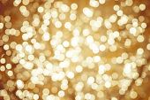 Golden Background With Natural Bokeh Defocused Sparkling Lights. Colorful Metallic Texture