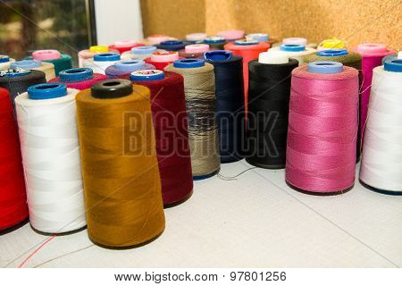 Many Reels Of  Threads Standing On The Table