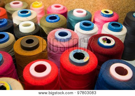 Many Reels Of  Threads Standing On The Table
