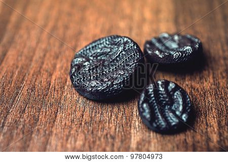 black buttons on wooden background