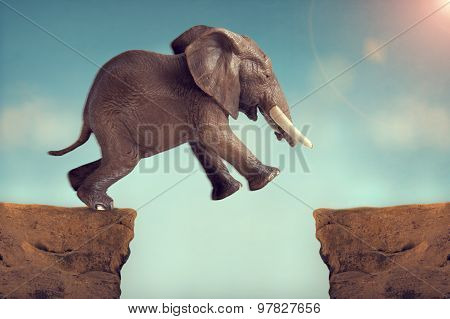 Leap Of Faith Concept Elephant Jumping Across A Crevasse