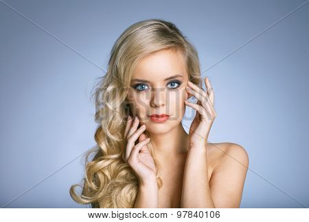 Portrait Of Beautiful Woman On Blue Background
