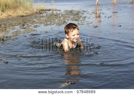 Boy Lying In The Healthy Mud