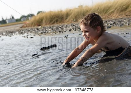 Child Applying Healthy Mud