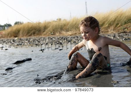Kid Applying Black Healing Clay
