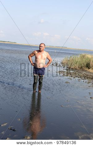 Senior Man Using Healing Mud