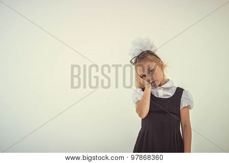 Schoolgirl with glasses standing worried