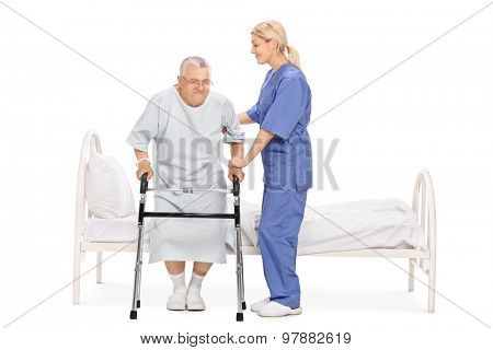Young female nurse helping a senior patient with a walker isolated on white background