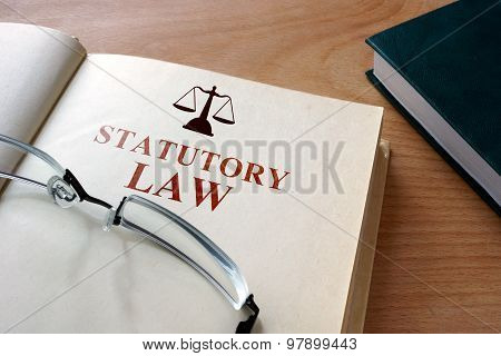 Notepad with words statutory law.