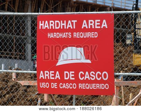 In the wake of several industrial accidents, the used of warning signs has increased at construction  sites. Here, the warning is that you must wear a hard hat at all times.