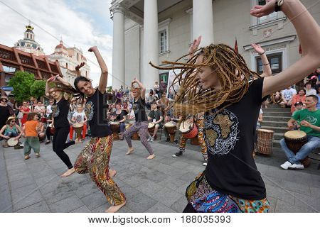 VILNIUS LITHUANIA - MAY 20: Unidentified musicians play drums and dancing in Street Music Day on May 20 2017 in Vilnius. Its a most popular event on May in Vilnius Lithuania