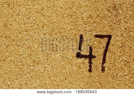 Number Fourty Seven On Orange Plaster Wall.