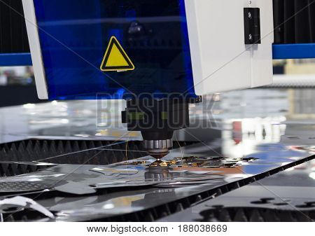 Technology High precision manufacturing concept.CNC Industrial laser cutting steel metal with bright sparks/ Intermarch 2017 Industrial Machinery Exhibition at Bitech Thailand - May 2017