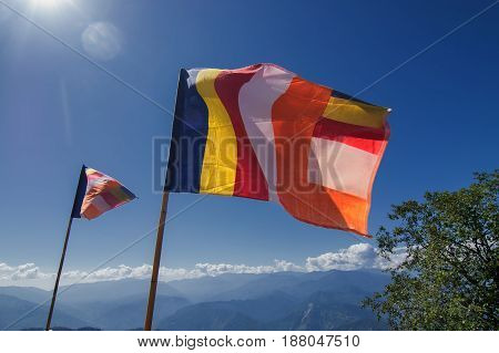 Colurful Buddhist Prayer flags are waving in strong wind under sunshine at Samdruptse huge buddhist memorial Monastery in Sikkim India.