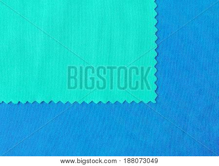 Green and bluel pieces of fabric samples closeup - can be used as a textile textural background with space for copy.