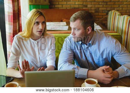 Business meeting in a cafe. Man and woman are negotiating.