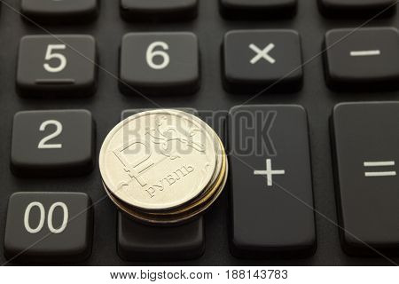 Russian coin one ruble on the background of banknotes
