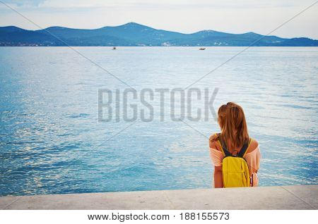 One Young Girl With A Backpack Sitting Peacefully