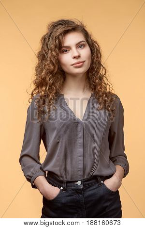 woman biege background curly hair blouse copy space