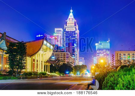 TAIPEI TAIWAN - APRIL 20: This is a view of Sun Yat-Sen memorial hall a famous historic landmark with Xinyi financial district in the background at night on April 20 2017 in Taipei