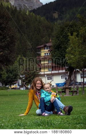 happy family. mother with daughter in a park in Canazei Italy