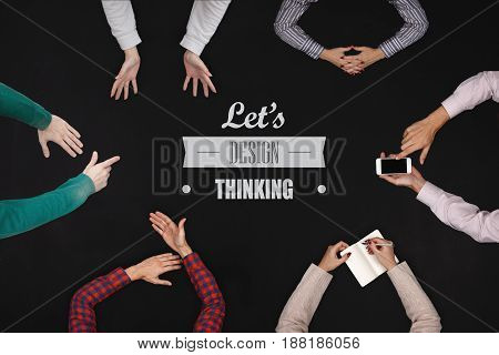 Teamwork concept - top view of six people work on a blackboard table.