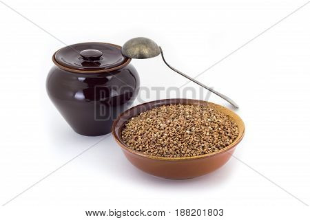 The Composition Of The Buckwheat Groats In A Clay Pial Next To A Clay Pot And A Copper Spoon,