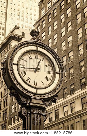 Manhattan Sidewalk Clock at 5th Avenue in New York City (USA). Edited as a vintage photo with dark edges.