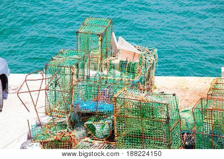 Lobster pots and crab pots drying in the sun on the pier Cascais Portugal