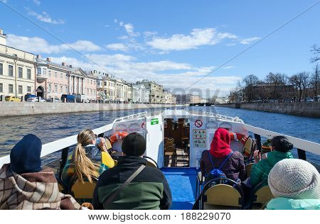 SAINT PETERSBURG RUSSIA - MAY 3 2017: Unknown tourists on excursion ship on Fontanka River St. Petersburg Russia