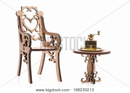 Coffee Grinder antique vintage brass ware on golden tray on decorative wooden table with engraved chair isolated on white background