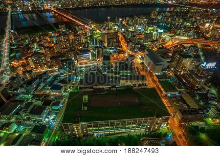 Aerial view of Osaka City Central business and Yodo River with its bridges at night. Osaka Skyline from Kita ward of Japan. Osaka is Japan's third largest city by population after Tokyo and Yokohama.