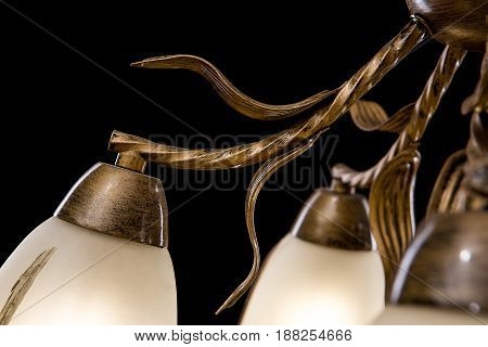 Modern Chandelier for interior decoration of the living room and kitchen. Bronze Chandelier details isolated on black background.