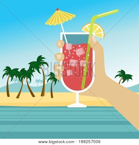 Hand holding a cocktail with icecubes, straw and umbrella over tropical beach