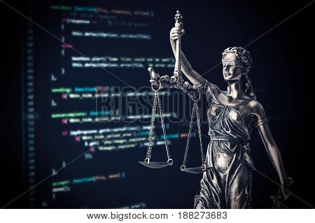 Justice Statue With Code On Monitor Device In Background