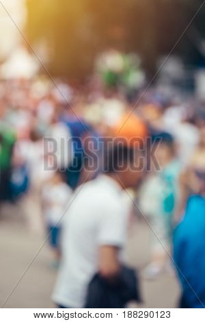 Blur defocussed crowd of people at public place such as street abstract background for general public or population opinion concept