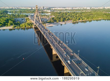 Aerial top view of Dnieper river and Moskovskiy bridge in city of Kiev, Ukraine