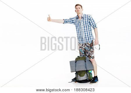 Travel man hitchhiking. young male hitchhiker on the white background
