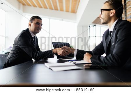 Sell Concept. Two Men Shake Hands And Get Agreement In Their Deal In Office.