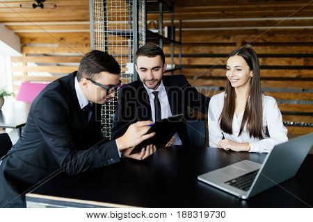 Sell Concept. Business Man  Explain His Team All Details Of Documents At Office Desk.