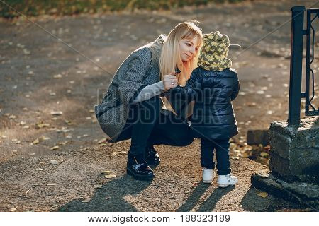 mother and little daughter in the autumn park