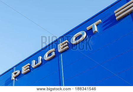 Moscow Russia - May 14 2016: The emblem Peugeot on the office of official dealer. Peugeot is a French car brand part of PSA Peugeot Citroen