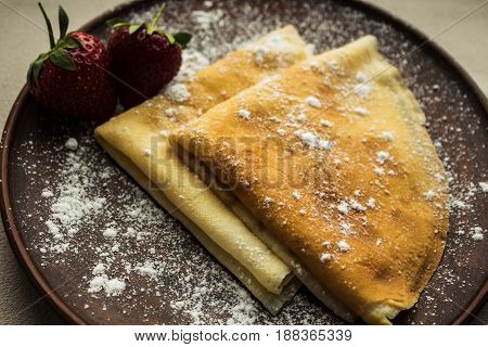 Pancakes With Strawberries And Powdered Sugar