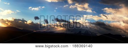 Altai Ukok the sunset over the mountains in cloudy cold weather. Wild remote places no one around. Rain clouds over the mountains
